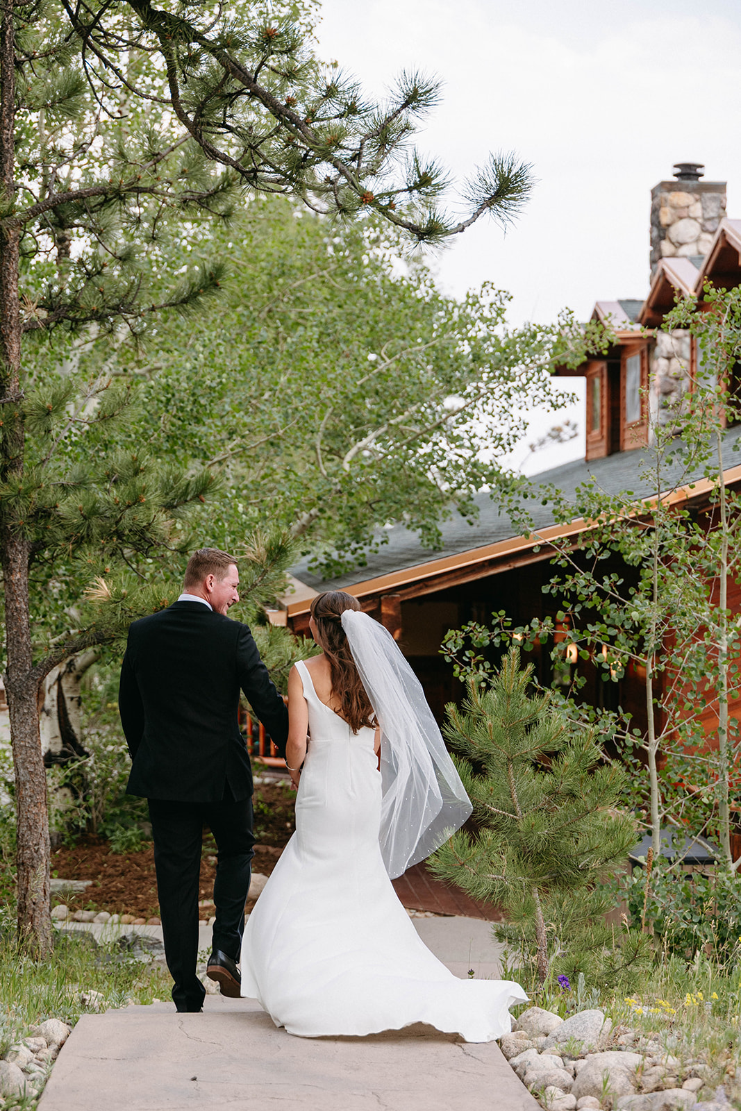 Jason and Amy kissing on the rocks framed by aspen trees
